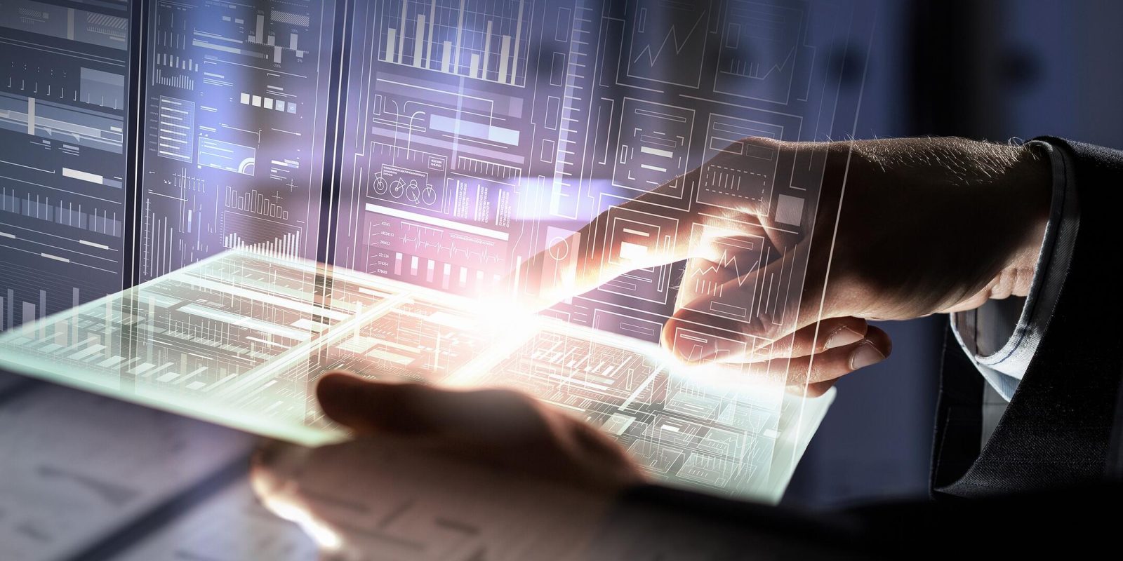 A person’s hand interacts with a glowing transparent tablet, surrounded by futuristic digital data displays and graphs, symbolizing advanced technology and data analysis.