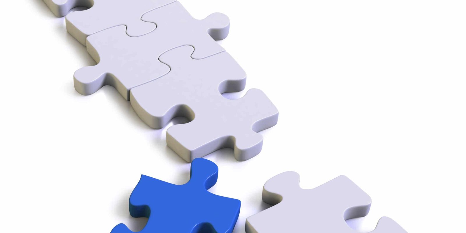 A nearly completed white puzzle with one missing piece, which is blue and placed near the empty spot, ready to be fitted in. The background is white, emphasizing the contrast between the blue and white pieces.