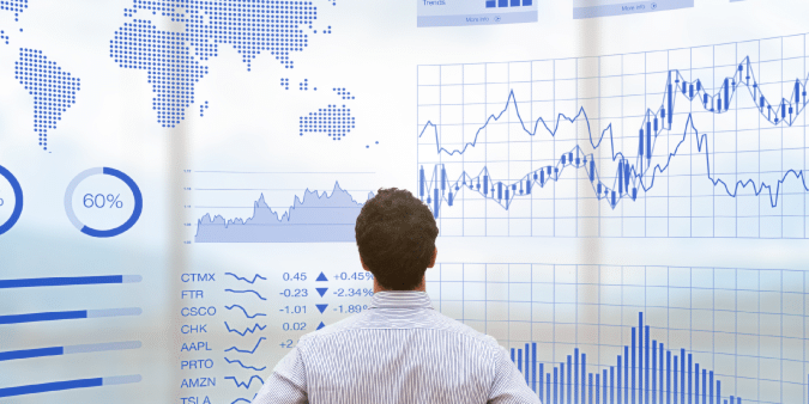 A man stands with hands on hips, facing a large digital screen displaying world maps, stock market data, charts, graphs, and various financial statistics in blue tones.