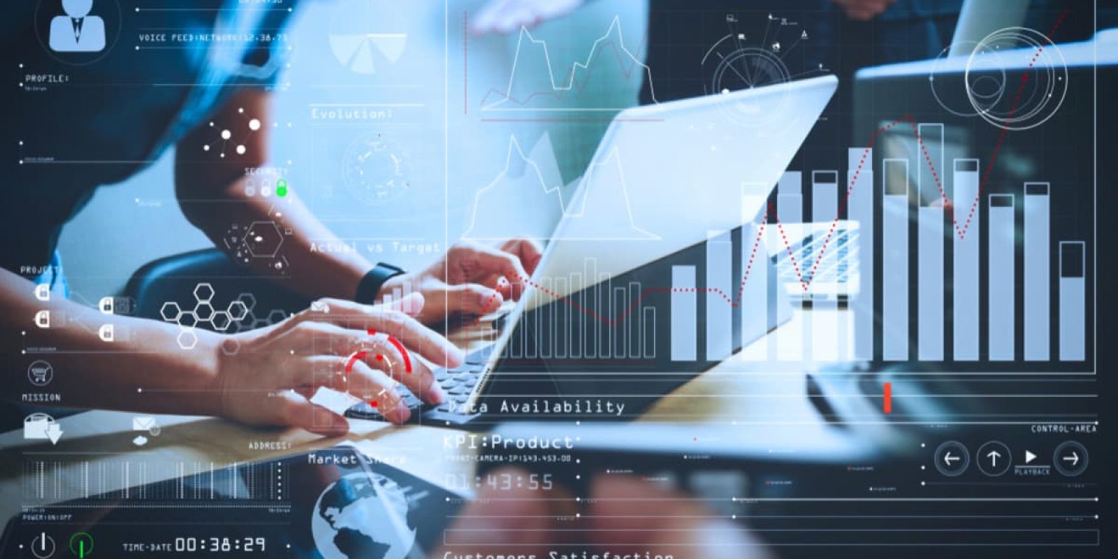 People working on laptops at a desk overlaid with digital graphs, charts, and data analytics visuals, representing teamwork, technology, and business data analysis.