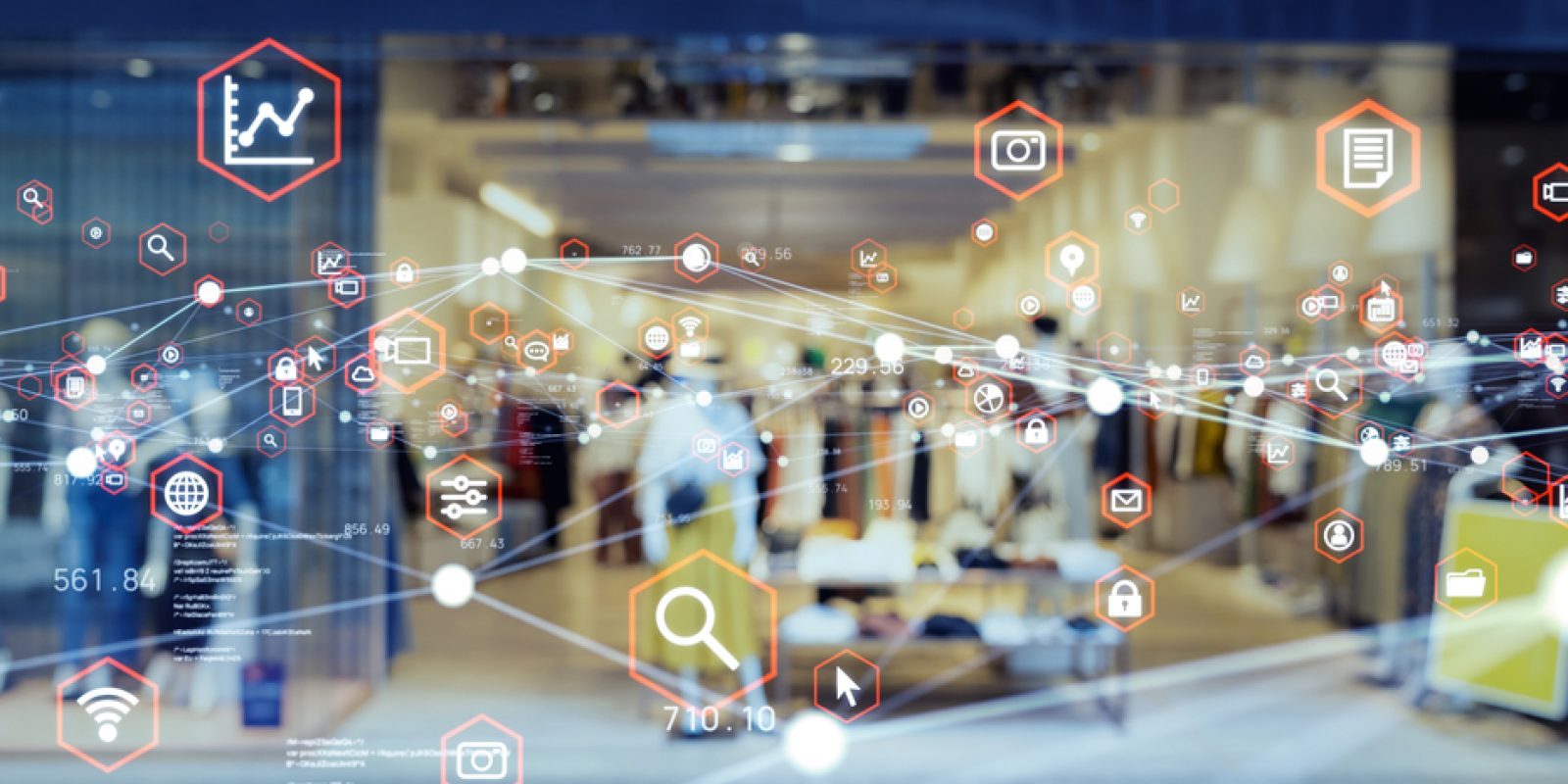 A clothing store interior is visible through a glass window overlaid with digital icons like graphs and shopping carts, symbolizing retail technology and data integration—key elements in understanding what is supply chain strategy today.