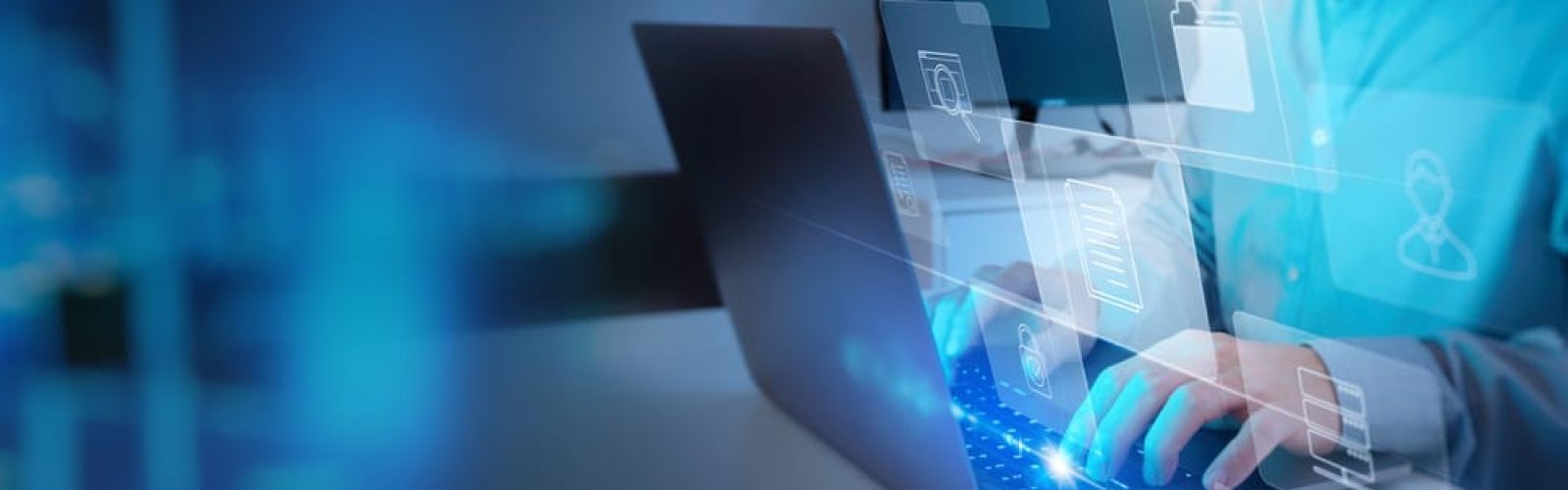 Person typing on a laptop with holographic icons for files, folders, and data storage, symbolizing digital data management and the comparison of business central vs finance and supply chain management in information technology.