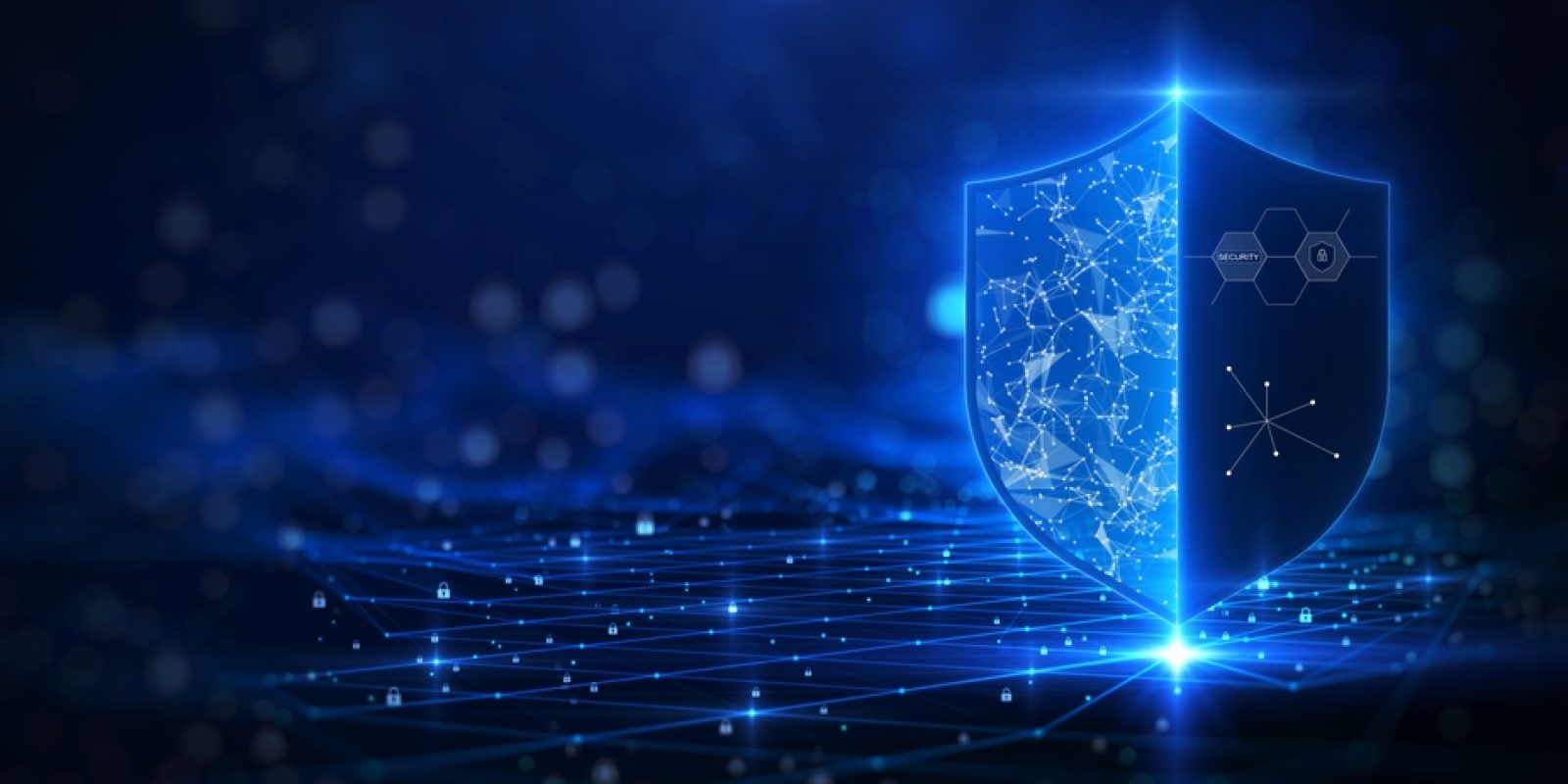 A glowing digital shield with network and security icons stands on a futuristic grid, symbolizing cybersecurity, Microsoft application management, and data protection on a blue tech-themed background.